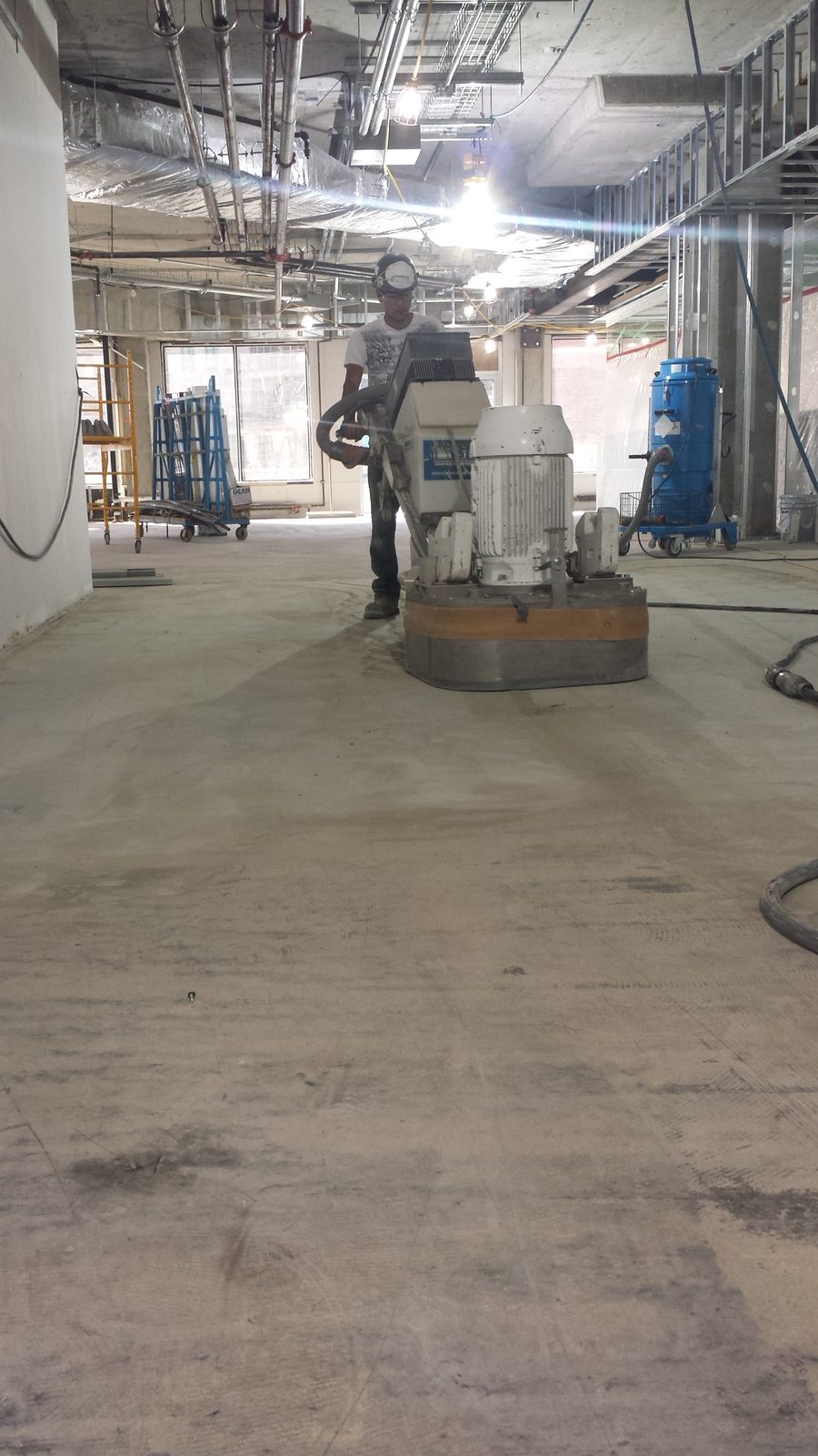 6D Concrete Restoration technician grinding a concrete floor